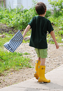 A student takes advantage of the outdoor learning lab provided by the school's sustainable landscape.