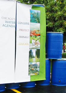The rain barrels have advanced the Chicago Water Agenda, cited here on banners to help educate residents. The rain barrels have advanced the Chicago Water Agenda, cited here on banners to help educate residents.