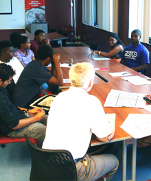 Participants of a design charette for the Harper High School learning landscape gathered around a table